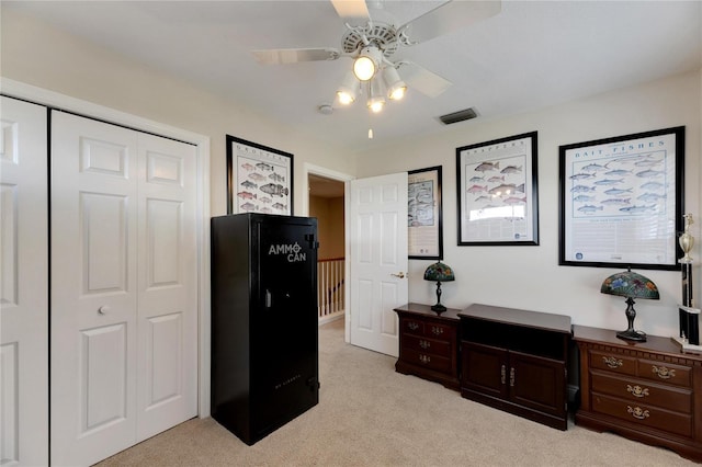 office area featuring light colored carpet, visible vents, and ceiling fan