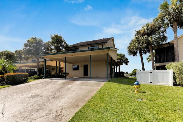 view of front of home with a front yard and a carport