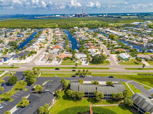 birds eye view of property featuring a water view and a residential view