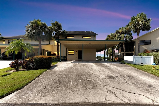 view of front of property featuring a yard and a carport