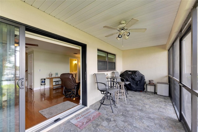 sunroom / solarium featuring ceiling fan