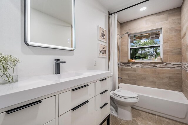 full bathroom featuring vanity, toilet, tile patterned flooring, and shower / bath combo