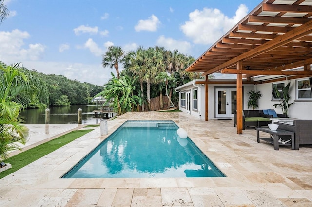 view of pool with a water view, outdoor lounge area, a patio area, and french doors