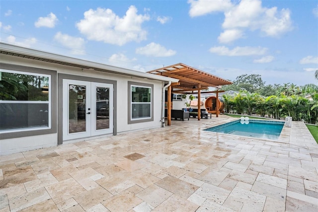 view of pool featuring a patio area and french doors