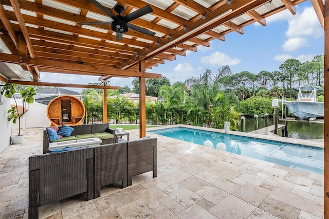 view of swimming pool with an outdoor living space, a patio, a water view, and ceiling fan