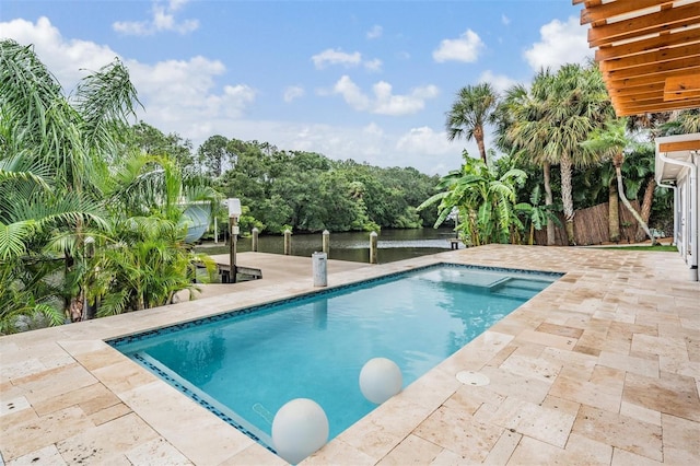 view of swimming pool with a patio area and a water view