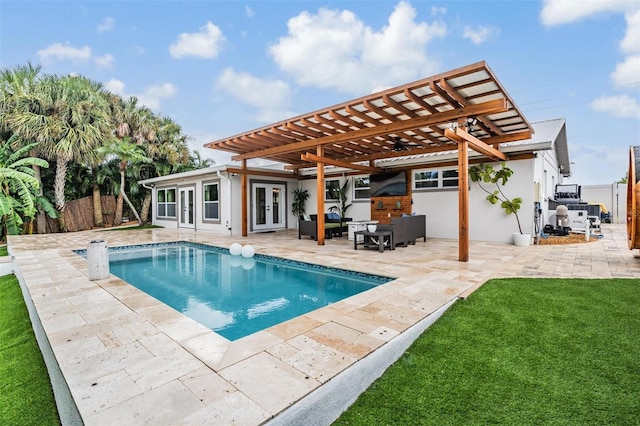 view of pool featuring a pergola, a yard, outdoor lounge area, a patio, and french doors