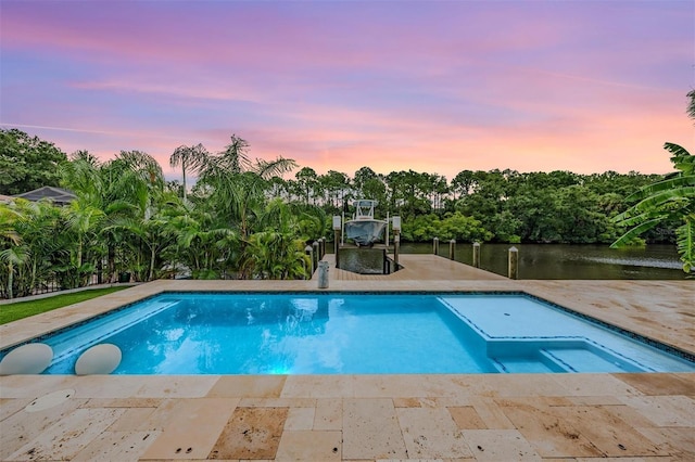 view of pool at dusk