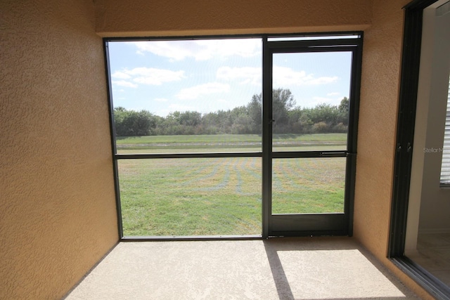 unfurnished sunroom featuring plenty of natural light