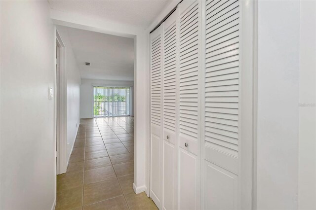 hallway featuring tile patterned flooring