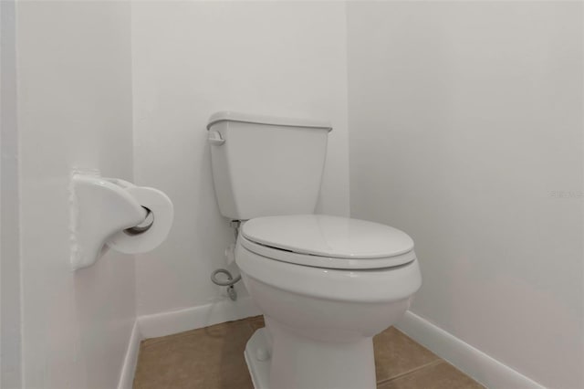 bathroom with tile patterned flooring and toilet