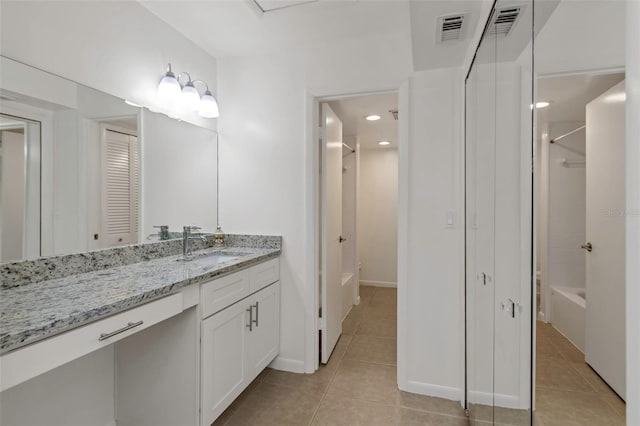 bathroom with vanity, tub / shower combination, and tile patterned floors