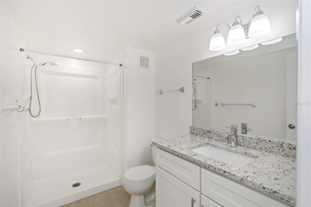 bathroom featuring vanity, toilet, tile patterned floors, and walk in shower