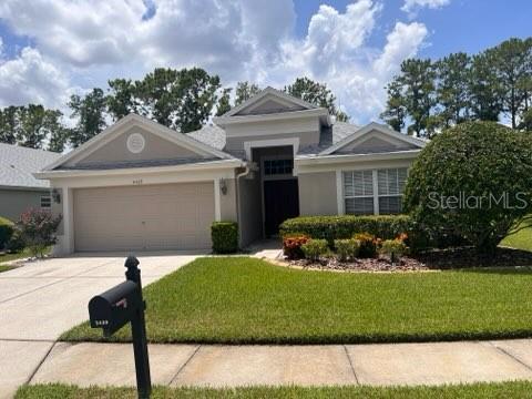 view of front of home with a garage and a front yard