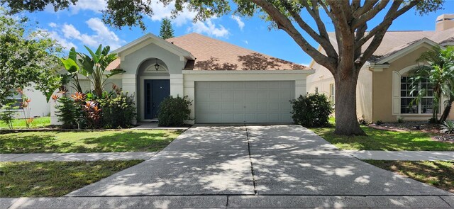 single story home with a front lawn and a garage