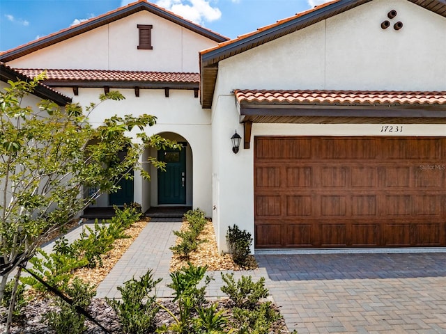 mediterranean / spanish-style home with a garage