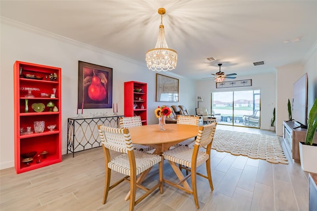 dining area featuring ornamental molding, ceiling fan with notable chandelier, and light hardwood / wood-style floors