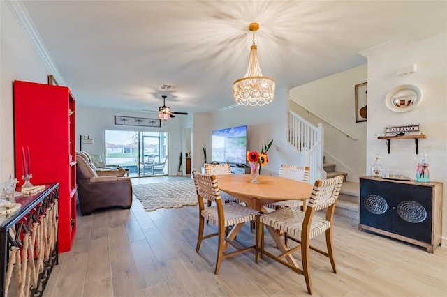 dining area featuring ceiling fan with notable chandelier, crown molding, and hardwood / wood-style floors