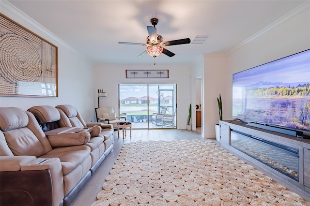 living room featuring light hardwood / wood-style flooring, ornamental molding, and ceiling fan