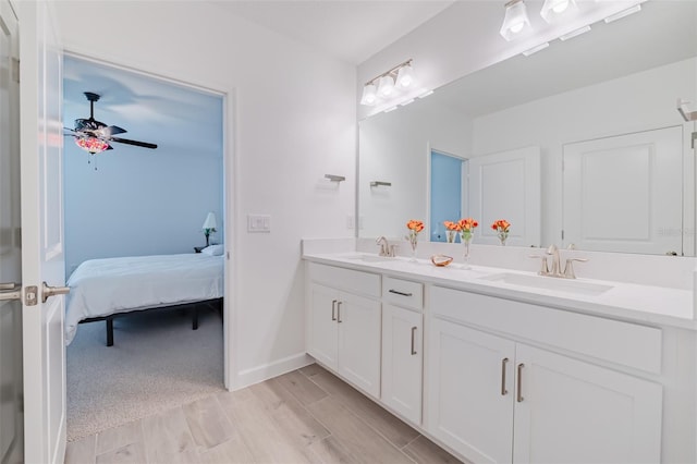 bathroom with ceiling fan and dual bowl vanity