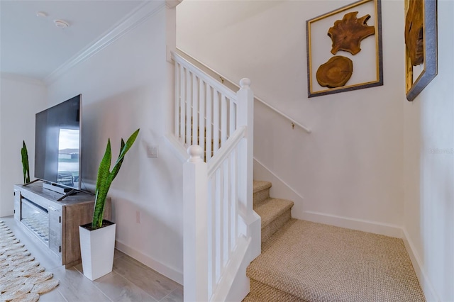 stairs featuring ornamental molding and light tile patterned floors