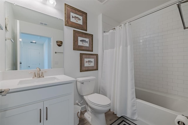 full bathroom featuring vanity, shower / bath combo, and toilet