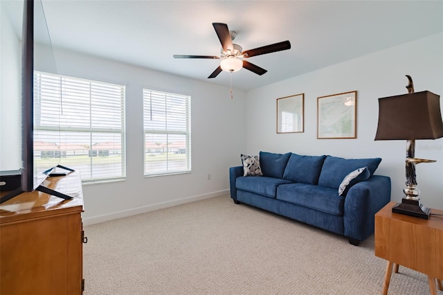 carpeted living room with ceiling fan