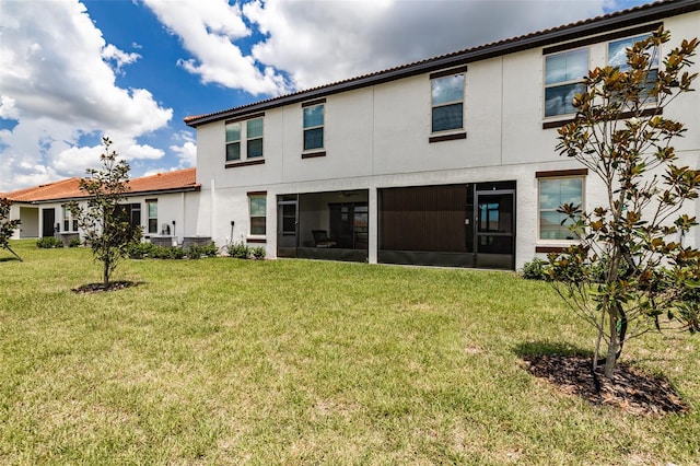 rear view of property featuring a yard