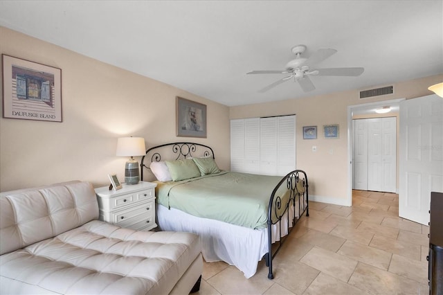 tiled bedroom featuring ceiling fan and a closet