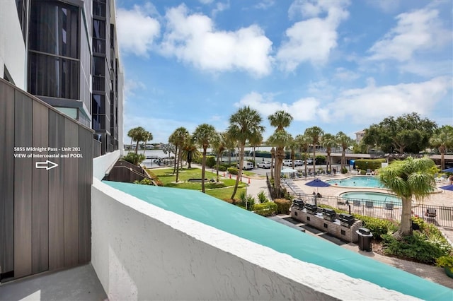 balcony featuring a community pool