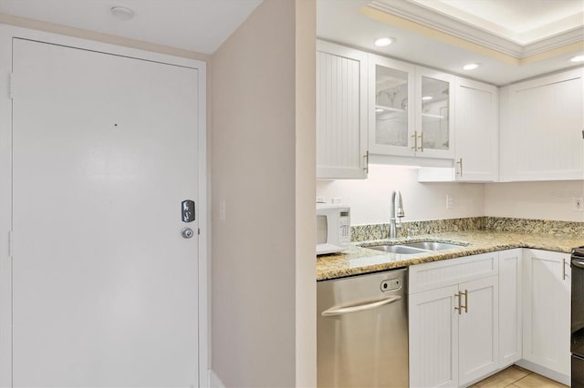 kitchen with light stone counters, sink, dishwasher, and white cabinetry