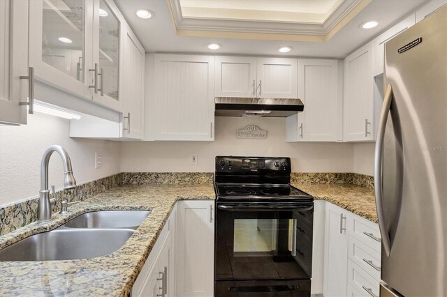 kitchen featuring electric range, a raised ceiling, stainless steel refrigerator, sink, and white cabinets