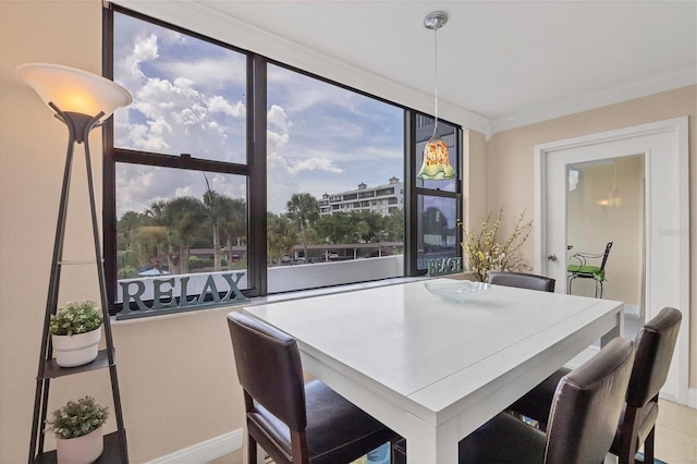 dining room featuring a healthy amount of sunlight and ornamental molding