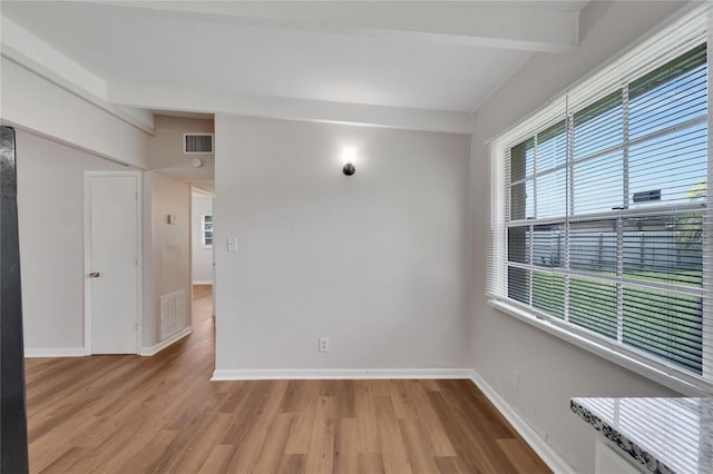 unfurnished room with hardwood / wood-style floors