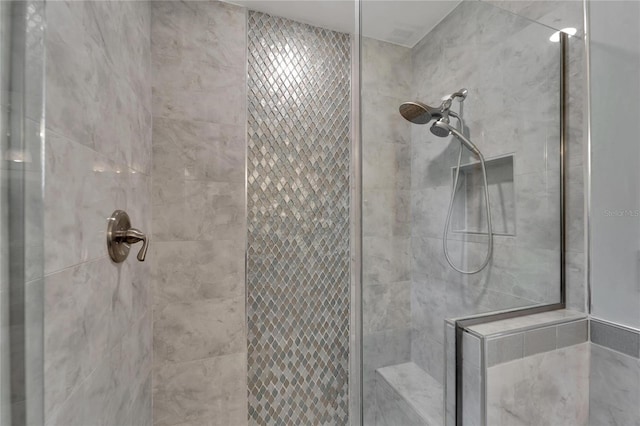 bathroom with a tile shower