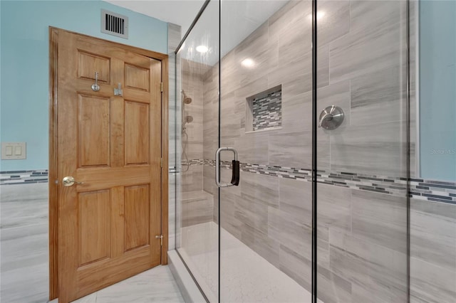 bathroom featuring tile walls and a shower with shower door