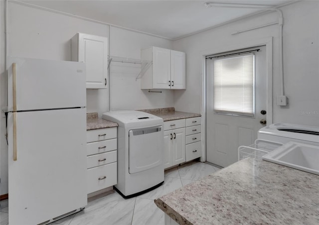609 Fox Hills Dr, Sun City Center, FL 33573 - washroom featuring washer / dryer and light marble finish flooring