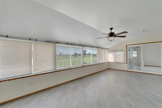 unfurnished sunroom featuring ceiling fan and vaulted ceiling