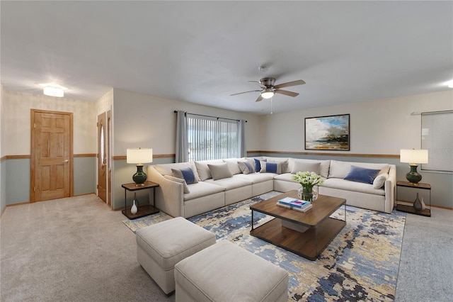 609 Fox Hills Dr, Sun City Center, FL 33573 - carpeted living room with ceiling fan and baseboards