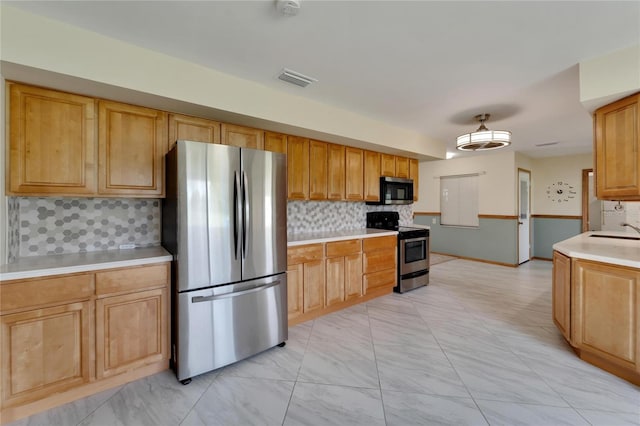 609 Fox Hills Dr, Sun City Center, FL 33573 - kitchen with stainless steel appliances, a sink, light countertops, and backsplash