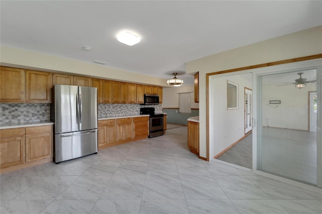 609 Fox Hills Dr, Sun City Center, FL 33573 - kitchen featuring stainless steel appliances, light countertops, backsplash, brown cabinets, and light marble finish floors