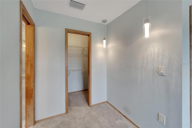 609 Fox Hills Dr, Sun City Center, FL 33573 - unfurnished bedroom with carpet flooring, a walk in closet, baseboards, and a closet