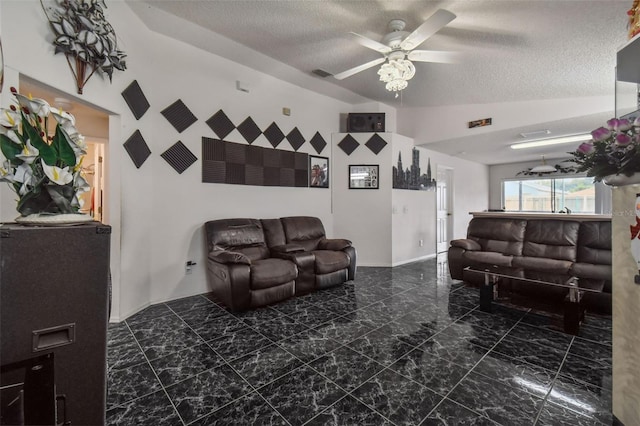 living room with a textured ceiling, tile patterned floors, and ceiling fan