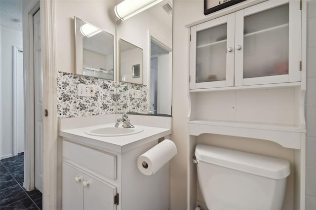 bathroom featuring vanity, toilet, and tile patterned flooring