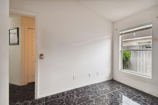 spare room with dark tile patterned flooring