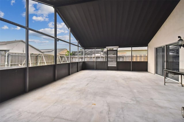 unfurnished sunroom with lofted ceiling