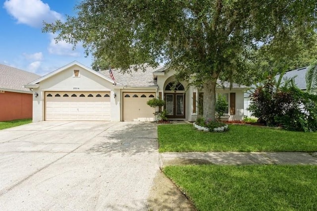 view of front of home featuring a garage and a front lawn