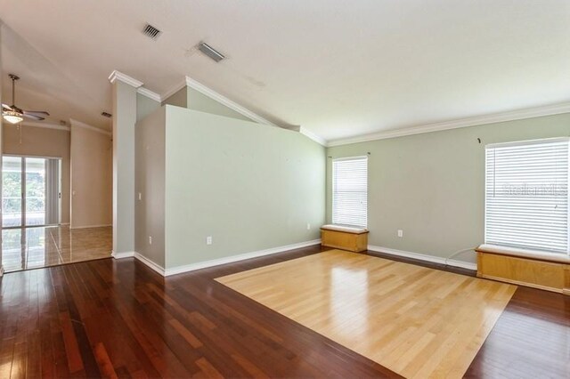 interior space featuring vaulted ceiling, crown molding, and hardwood / wood-style floors