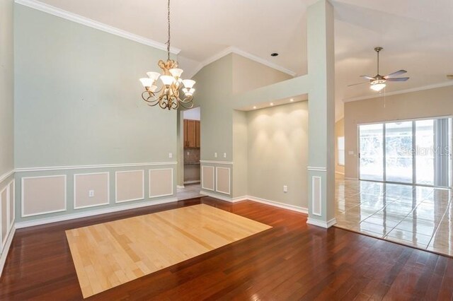 interior space featuring dark wood-type flooring, crown molding, and ceiling fan with notable chandelier