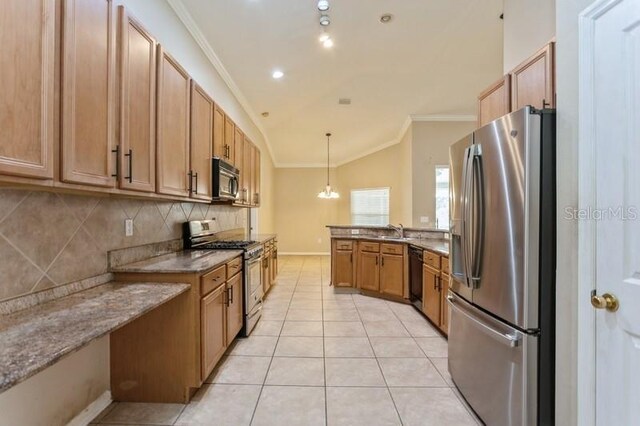 kitchen with pendant lighting, light stone countertops, decorative backsplash, and stainless steel appliances